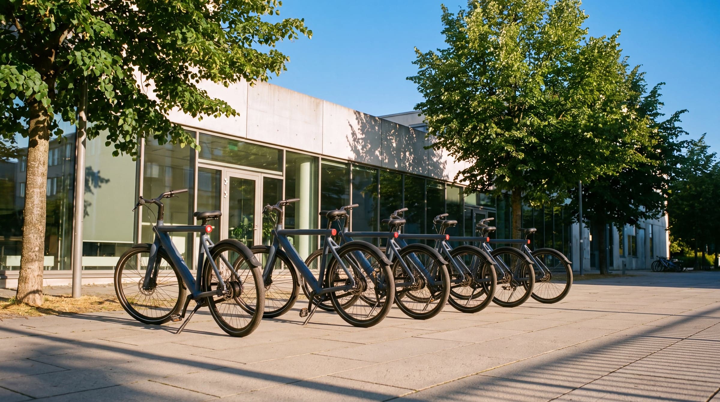 Six Sykla bikes in company livery stand outside a light Oslo office early in the morning.